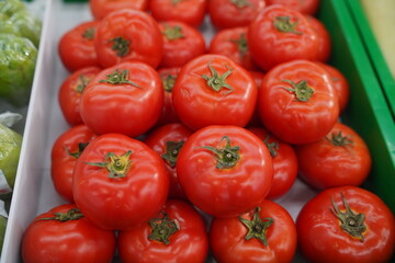 Lots of red ripe tomatoes of different sizes. Harvest of ripe tomatoes. Vegetables grown in the village.