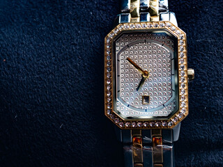 Picture of luxury woman wrist watch. Thus watch on a gold color and silver dial