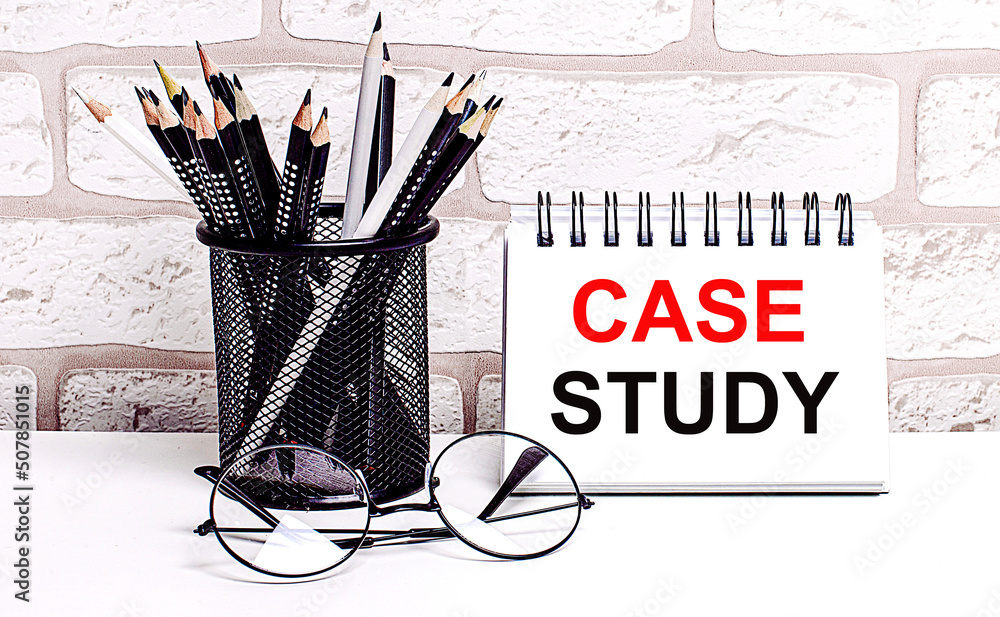 Poster a workplace in the house with glasses, pencils in a stand and a notebook with text case study on a b