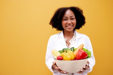 Portrait African American Positive dietitian with fruits and vegetables for healthy eating and...