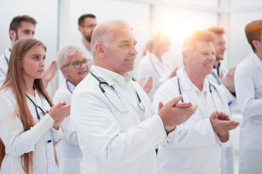 Large Group Of Medical Practitioners Applauding Together.