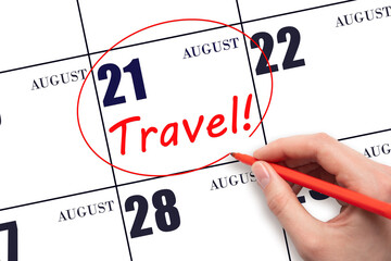 21st day of August. Hand drawing a red circle and writing the text TRAVEL on the calendar date 21 August. Travel planning. Summer month. Day of the year concept.