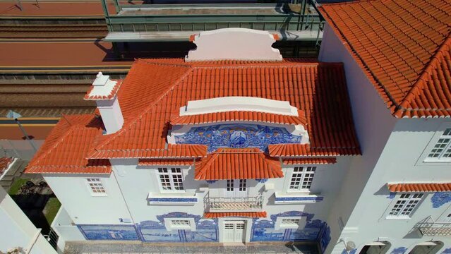 aerial drone view of the Historic building of old Aveiro Railway station ornamented with typical blue azulejo and red roof