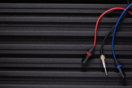 Acoustic panel and cable plug on foam rubber background texture. Material for soundproof in studio concept