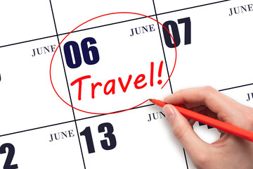6th day of June. Hand drawing a red circle and writing the text TRAVEL on the calendar date 6 June....