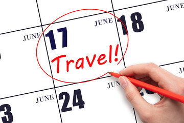 17th day of June. Hand drawing a red circle and writing the text TRAVEL on the calendar date 17...
