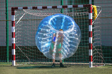 football ball game in inflatable transparent spheres. sports and entertainment. active recreation...