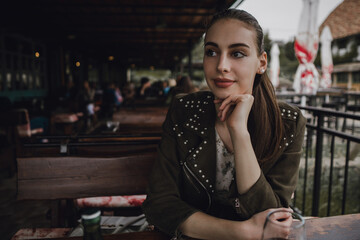 Beauty young brunette woman sitting at the bar