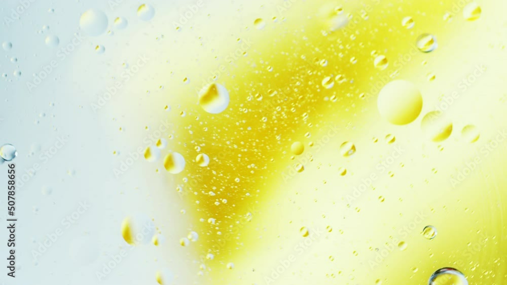 Poster real close up oil bubbles in water rotation with color gradient abstract mixing background.