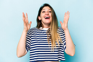 Young caucasian woman isolated on blue background laughs out loudly keeping hand on chest.
