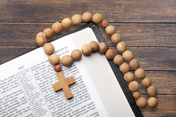 Religious wooden cross on the pages of a bible