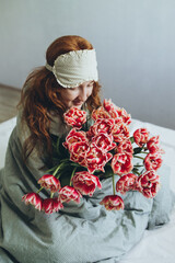 Red-haired girl with a bouquet of tulips