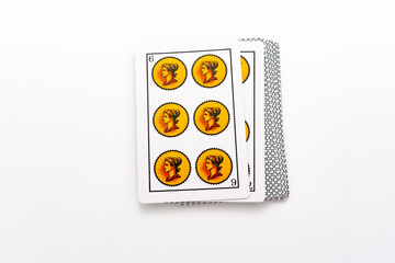 Spanish card game, spanish deck Tarot cards, the gold (coins) card in the foreground.