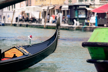 Fototapeta na wymiar View on Venice city life with detail of gondola close-up by the canal, summer Italy.