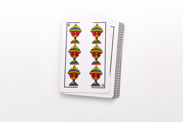 Spanish card game, spanish deck Tarot cards, the cups card in the foreground.