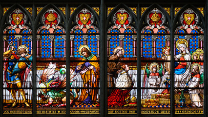 Stained-glass window: young emperor Franz Joseph kneeling in front of the Virgin Mary and Jesus. Votivkirche – Votive Church, Vienna, Austria. 2020-07-29.  - obrazy, fototapety, plakaty