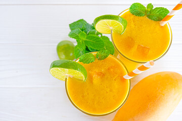 Orange smoothies yellow colorful fruit juice milkshake blend beverage healthy high protein the taste yummy In glass,drink to lose weight drink episode morning on white gray background.