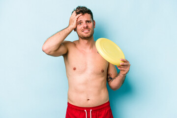 Young caucasian man playing with frisky isolated on blue background being shocked, she has...