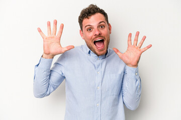 Young caucasian man isolated on white background receiving a pleasant surprise, excited and raising...