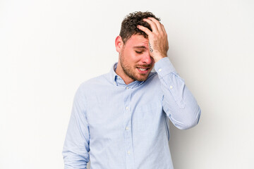 Young caucasian man isolated on white background forgetting something, slapping forehead with palm and closing eyes.