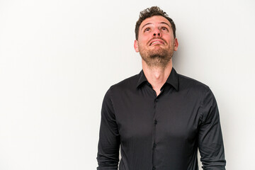 Young caucasian man isolated on white background shouting very angry, rage concept, frustrated.