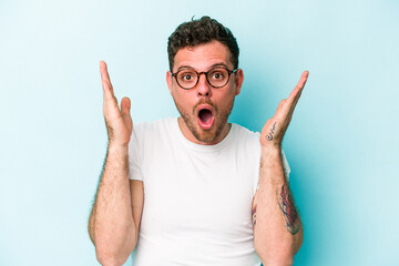 Young caucasian man isolated on blue background surprised and shocked.