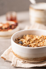 Delicious homemade granola in a bowl on gray background. Breakfast. Healthy food sweet dessert snack. Diet nutrition concept. Vegetarian food.