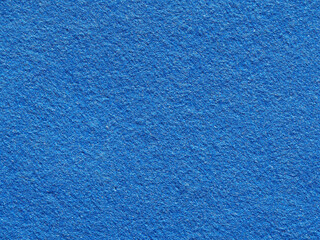 Bright blue rough textured background. Close-up of the texture of fleecy fabric. Blue Synthetic fiber surface