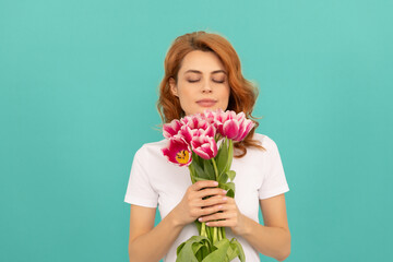 girl smell tulip flower bouquet on blue background