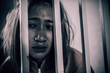 Portrait of women desperate to catch the iron prison,prisoner concept,thailand people,Hope to be...