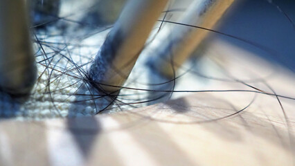 Macro images of black damage hair fall sticked on wood brush with dust for representative of...
