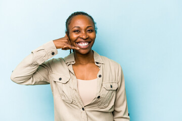 Young african american woman isolated on blue background showing a mobile phone call gesture with fingers.