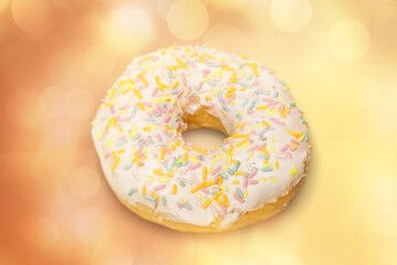 Sweet tasty white glazed donut on the desk