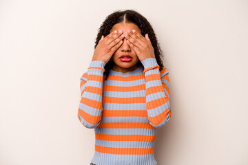 Young African American woman isolated on white background afraid covering eyes with hands.