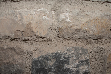 Background of old bricks of gray and brown tones. Different sizes.