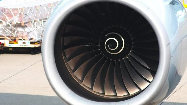 Airplane turbo engine blades fan on the right wing and test moving before take off for long flight to Japan and other country in international airport of Bangkok Thailand.