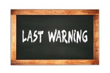 Fototapeta premium LAST WARNING text written on wooden frame school blackboard.
