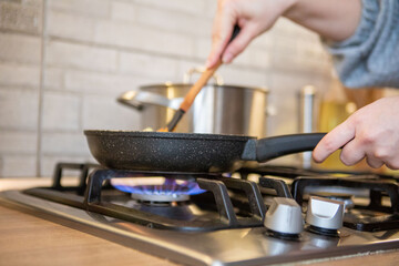 frying pan on cooking top blue flame
