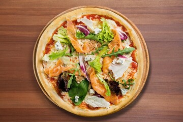 Sliced spicy tasty pizza with onion on a rustic table.