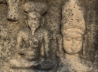 Fototapeta na wymiar Indian Architecture of 5th Century. Stone sculptures on the wall inside the Neelkanth temple in Kalinjar Fort, Uttar Pradesh, India.
