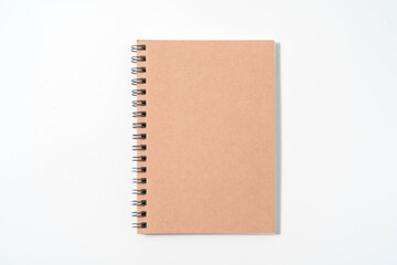 Fototapeta premium Brown spiral notebook isolated on white background.top view