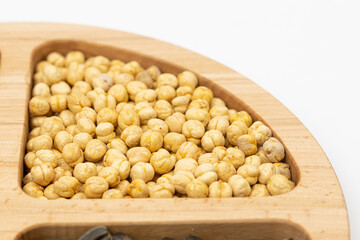 Peanuts cashew sunflower seeds and chickpea in the wooden bowl above white background
