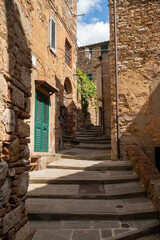 Fototapeta na wymiar An alley in the historic center of Campiglia Marittima Livorno Tuscany with a stone staircase