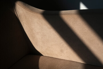 Shadowy abstract fabric detail of an armchair. Horizontal beige fabric or textile detail as...