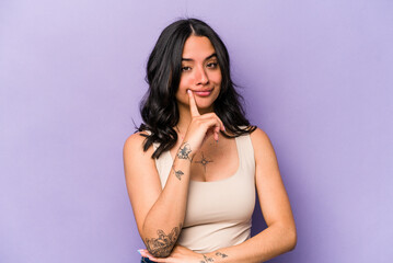 Young hispanic woman isolated on purple background contemplating, planning a strategy, thinking about the way of a business.