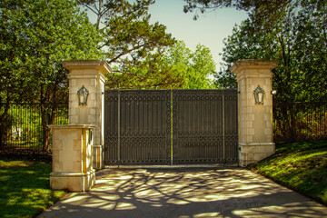 Closed impressive wrought iron luxury  security gate with key pad for private residential estate in...