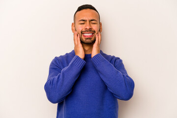 Young hispanic man isolated on white background crying, unhappy with something, agony and confusion concept.