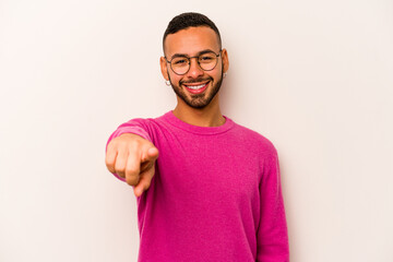Young hispanic man isolated on white background cheerful smiles pointing to front.