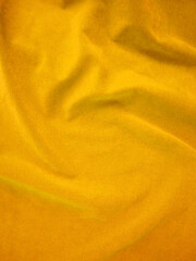Yellow velvet fabric texture used as background. Empty yellow fabric background of soft and smooth textile material. There is space for text.