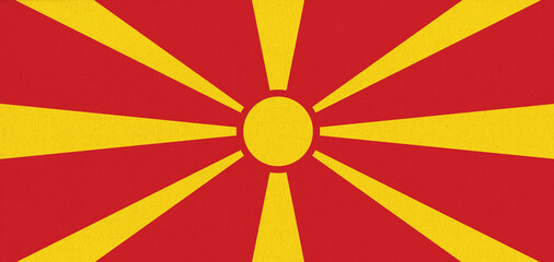 Flag of North Macedonia. North Macedonia state symbol. Flag on fabric surface